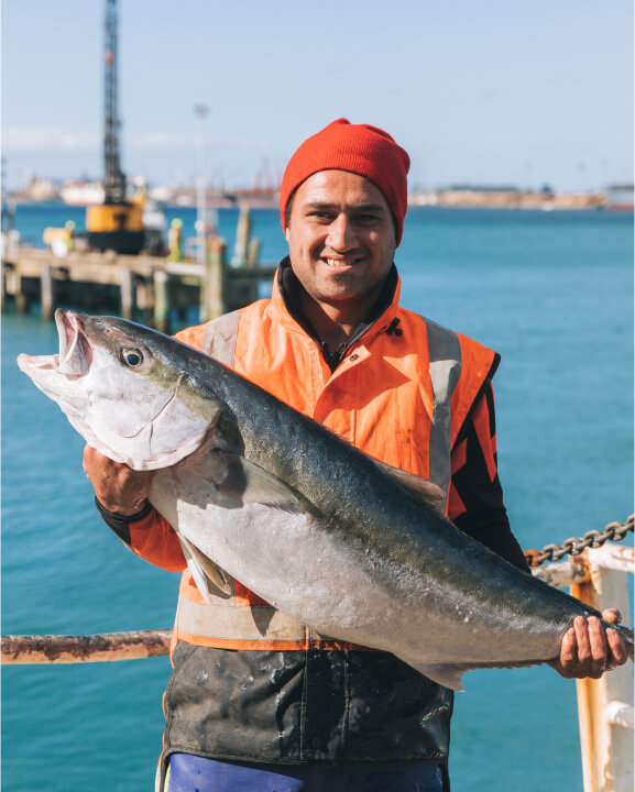 Image of staff member holding up a large fish